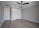 Neutral bedroom featuring a ceiling fan, closet, and wood-look floors at 1706 Cheltenborough Dr, Orlando, FL 32835