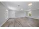 Large bonus room with light wood floors, neutral walls, recessed lights, and ample storage at 1706 Cheltenborough Dr, Orlando, FL 32835