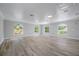 Spacious bonus room with wood floors, neutral walls, recessed lighting, and three arched windows at 1706 Cheltenborough Dr, Orlando, FL 32835