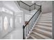 Home foyer featuring stairs to the second floor, marble floors, and glass doors to the exterior at 1706 Cheltenborough Dr, Orlando, FL 32835