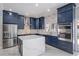 Beautiful kitchen with blue cabinets, marble countertops, stainless steel appliances, and an island at 1706 Cheltenborough Dr, Orlando, FL 32835