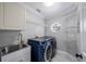 Laundry room featuring modern appliances, marbled floors, and wire shelving at 1706 Cheltenborough Dr, Orlando, FL 32835