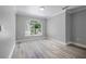 Bright living room with a large arched window and light wood flooring at 1706 Cheltenborough Dr, Orlando, FL 32835