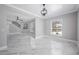 Open-concept living room with marble flooring, modern chandelier, and views of connecting rooms at 1706 Cheltenborough Dr, Orlando, FL 32835