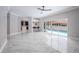 Open-concept design shows modern kitchen, living space, breakfast bar, and sliding glass doors to a pool at 1706 Cheltenborough Dr, Orlando, FL 32835