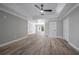 Spacious living room with tray ceilings, wood-look flooring, and natural light at 1706 Cheltenborough Dr, Orlando, FL 32835