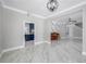Spacious living room with adjacent kitchen featuring marble floors, accent wall, and modern lighting at 1706 Cheltenborough Dr, Orlando, FL 32835