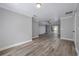 Open-concept living space with wood-look flooring and plenty of natural light at 1706 Cheltenborough Dr, Orlando, FL 32835