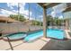 This screened-in pool features a hot tub and waterfall, offering a relaxing backyard oasis at 1706 Cheltenborough Dr, Orlando, FL 32835