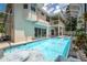 Beautiful screened-in pool with rock waterfall feature and spacious deck, perfect for outdoor entertaining at 1706 Cheltenborough Dr, Orlando, FL 32835