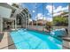 Relaxing screened-in pool with spa and rock waterfall feature enhance the backyard's appeal at 1706 Cheltenborough Dr, Orlando, FL 32835