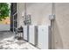 Tesla powerwall installation with outdoor grilling area and patio at 1706 Cheltenborough Dr, Orlando, FL 32835