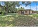Expansive backyard with lush ground cover, trees, and the rear facade of the house at 1711 37Th St, Orlando, FL 32839