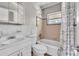 Modest bathroom featuring a shower-tub combo, toilet, and vanity with neutral-toned tilework at 1711 37Th St, Orlando, FL 32839