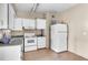 Functional kitchen with white cabinets, standard appliances, and tile flooring at 1711 37Th St, Orlando, FL 32839