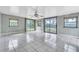 Spacious room with tile floor, windows, and sliding glass door at 1711 37Th St, Orlando, FL 32839