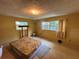 Bright bedroom featuring a ceiling fan, two windows and neutral colored walls at 1730 Oneco Ave, Winter Park, FL 32789
