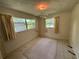 Bright bedroom featuring neutral colored walls, two large windows and beige carpet at 1730 Oneco Ave, Winter Park, FL 32789