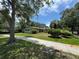 A cozy single-story home with muted colors, shutters and mature landscaping at 1730 Oneco Ave, Winter Park, FL 32789