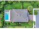 Aerial view showcases a backyard pool, a well-manicured lawn and mature landscaping at 1938 Filly Trl, Oviedo, FL 32765