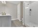 Modern bathroom featuring a glass-enclosed shower, light gray vanity, and wood-look tile flooring at 1938 Filly Trl, Oviedo, FL 32765