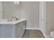 Bathroom with a double sink vanity, neutral paint, and wood look tile flooring at 1938 Filly Trl, Oviedo, FL 32765