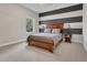 Bedroom with a striped accent wall, a wood bed frame, and two side tables at 1938 Filly Trl, Oviedo, FL 32765