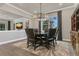 Elegant dining area featuring a modern chandelier, stylish furnishings, and a window with natural light for Gathering meals at 1938 Filly Trl, Oviedo, FL 32765