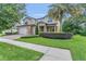 Charming two-story home with a well-manicured lawn and mature landscaping at 1938 Filly Trl, Oviedo, FL 32765