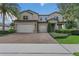 Charming two-story home with three-car garage, brick-paved driveway, and lush landscaping at 1938 Filly Trl, Oviedo, FL 32765