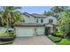 Two-story home boasting a three-car garage, well-maintained landscaping, and a brick-paved driveway at 1938 Filly Trl, Oviedo, FL 32765