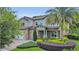 Charming two-story home with manicured landscaping, a brick driveway and a welcoming front entrance with stone accents at 1938 Filly Trl, Oviedo, FL 32765