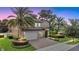 Beautiful two-story home featuring a lush landscaped yard, brick driveway, and a three-car garage at 1938 Filly Trl, Oviedo, FL 32765