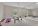 Spacious home gym featuring mirrored wall, weight equipment, carpet flooring and windows for natural light at 1938 Filly Trl, Oviedo, FL 32765