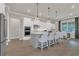 Modern kitchen with stainless steel appliances, a kitchen island with barstool seating, and pendant lighting at 1938 Filly Trl, Oviedo, FL 32765
