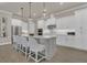 Bright, modern kitchen with white cabinetry, stainless steel appliances, an island with bar seating, and pendant lighting at 1938 Filly Trl, Oviedo, FL 32765