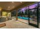 Covered lanai overlooking a private pool at dusk, with comfortable seating and ample space for relaxation at 1938 Filly Trl, Oviedo, FL 32765