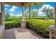 Professionally landscaped garden area with manicured hedges and colorful flowerbeds seen from the porch at 1938 Filly Trl, Oviedo, FL 32765