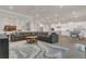 Spacious living room connected to the kitchen, featuring a large sectional and a stylish rug, perfect for relaxation at 1938 Filly Trl, Oviedo, FL 32765