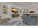 Open-concept living room with modern decor, built-in features, and lots of seating at 1938 Filly Trl, Oviedo, FL 32765