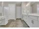 Bright bathroom featuring double sinks, a makeup vanity, and a walk-in shower at 1938 Filly Trl, Oviedo, FL 32765
