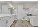 Well-lit main bathroom with double vanity, walk-in shower, makeup vanity, and large mirrors at 1938 Filly Trl, Oviedo, FL 32765