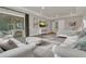 Bright main bedroom with sitting area, tray ceiling, and sliding glass door access to outdoor living space at 1938 Filly Trl, Oviedo, FL 32765