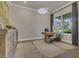 Bright home office with a classic wooden desk, a stylish pendant light, and a serene garden view at 1938 Filly Trl, Oviedo, FL 32765