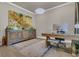 Bright home office with a stylish desk, a statement painting, and ample storage, creating a productive workspace at 1938 Filly Trl, Oviedo, FL 32765