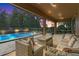 Inviting covered patio with comfortable seating overlooks the sparkling pool and lush backyard at 1938 Filly Trl, Oviedo, FL 32765