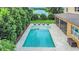 Beautiful backyard featuring a large swimming pool, spa, outdoor seating, and a serene lake view at 1938 Filly Trl, Oviedo, FL 32765