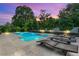 Backyard with a sparkling pool, spa, and comfortable lounge chairs; perfect for entertaining at 1938 Filly Trl, Oviedo, FL 32765