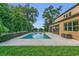 Beautiful backyard swimming pool with a travertine deck, screened lanai, and well-maintained landscaping at 1938 Filly Trl, Oviedo, FL 32765