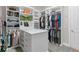 Spacious walk-in closet with custom shelving, center island, and ample storage space at 1938 Filly Trl, Oviedo, FL 32765